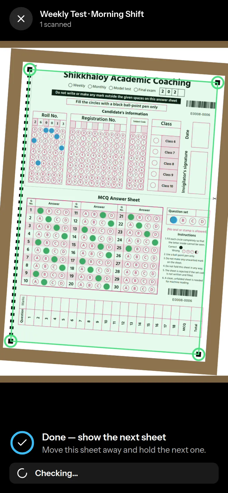 Live OMR scan on a phone: the sheet is outlined in green and every filled bubble is marked